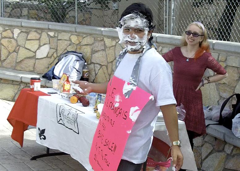 Jesus Gonzalez, senior psychology major and member of the French Club, takes pies to the face outside the Liberal Arts building in exchange for a $1 donation from students.