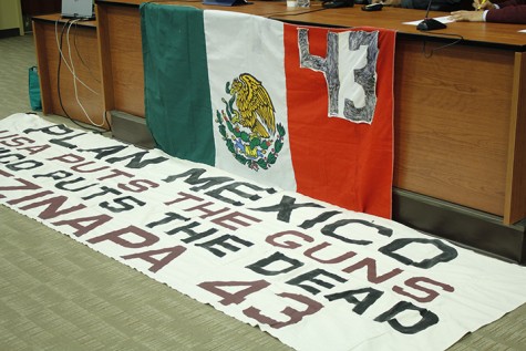 A sign reading “USA puts the guns, Mexico puts the dead, Ayotzinapa 43” lies on the floor of a room at the University of the District of Columbia. It is intended to address the issue of ongoing violence in Mexico and that the U.S. it the main supplier of guns to Mexican drug cartels. 