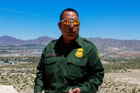 Adrian Calvillo, Border Patrol Agent, speaks to UTEP students about the border fence.