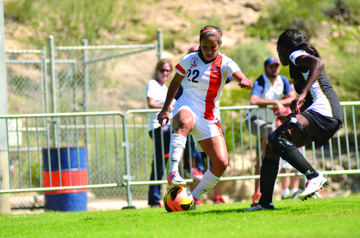 Senior midfielder Gina Soto takes on a Golden Eagles defender.