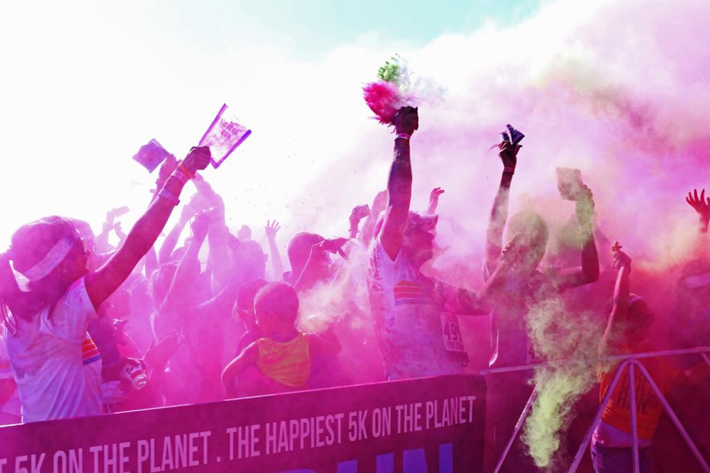 Ray Jairez (Middle Right) throws his color in the air during a color throw at the Color Run event at Ascarate Park.