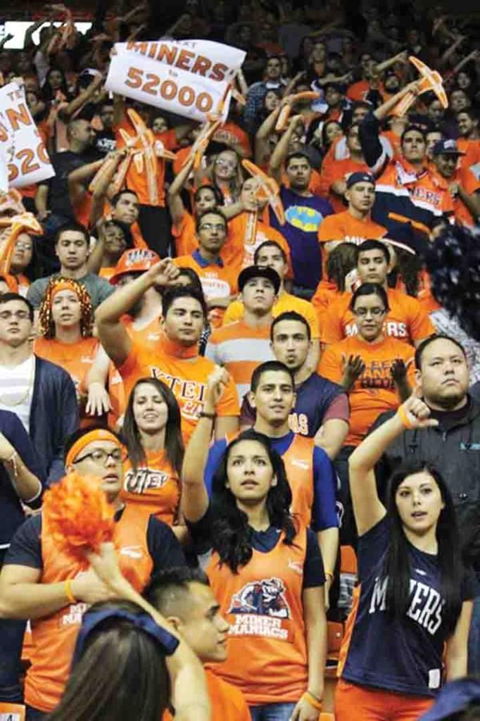 Students cheering on the Miners at a mens basketball game. 