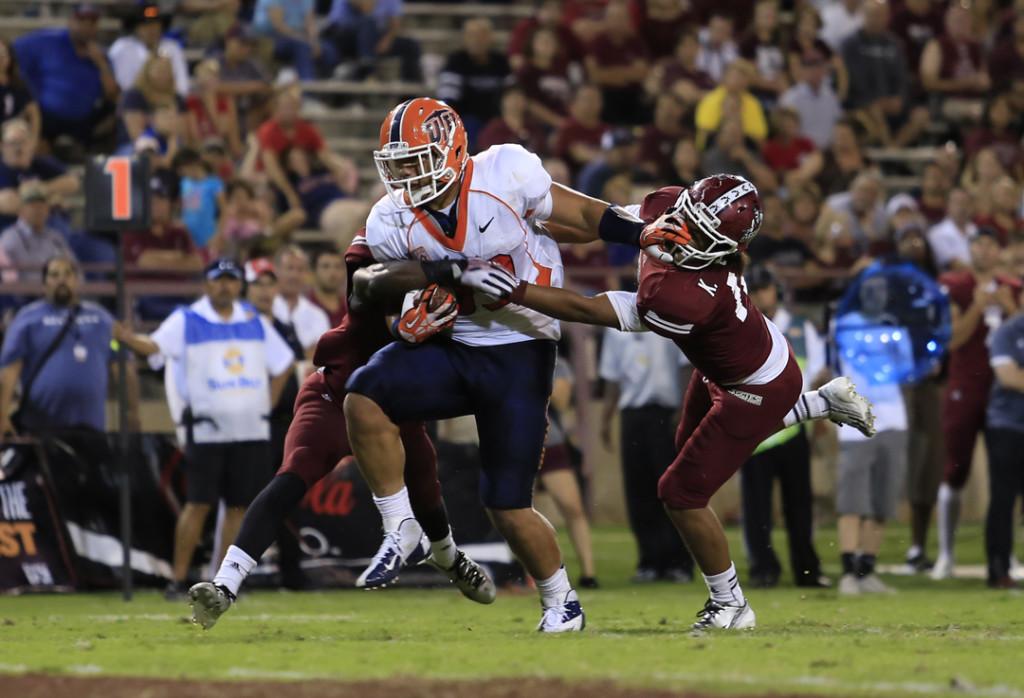 Freshman+running+back+Darrin+Laufasa+gets+past+two+Aggie+defensive+backs+to+score+on+his+first+career+touchdown+on+Sept.+14.