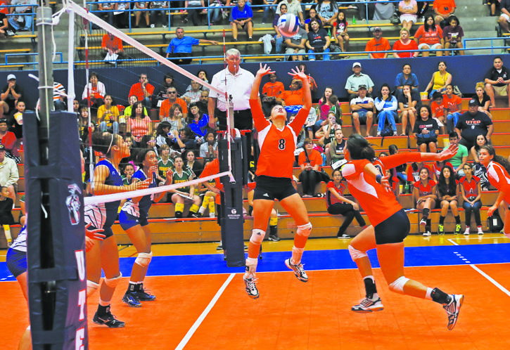 Senior setter Malia Patterson sets teammate Xitlali Herrera for the kill against Hampton.