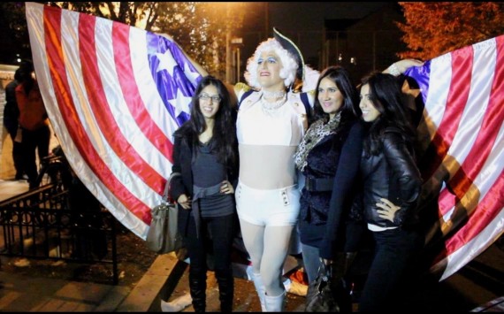 Georgette Washington, better known as Jeremy Raush, poses with spectators Tuesday after the 17th Street High Heel Race. In its 27th year, the race draws politicians and hundreds of spectators to the Dupont Circle neighborhood. 