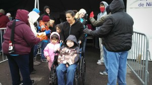 Kids receiving free Toms shoes are congratulated by volunteers on their way out of the tent.