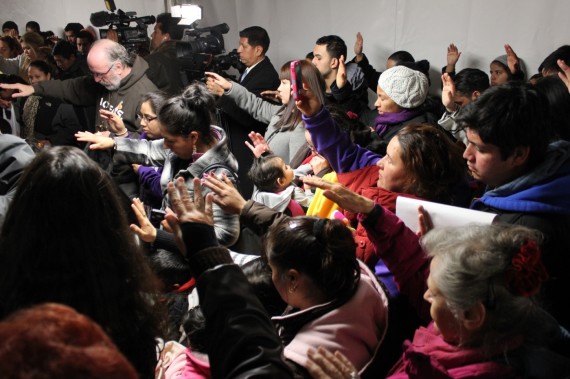 Immigration reform supporters give their blessing Tuesday to people who are fasting in tents on the National Mall near the Capitol. Five volunteers have committed to fasting for an immigration reform bill that includes to citizenship
