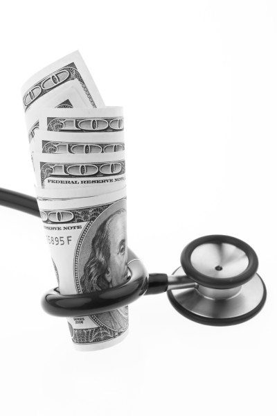 bigstock-Dollar-Bills-And-Stethoscope-9567119