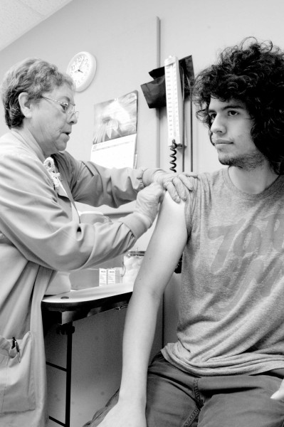 A student receieves the flu vaccine that was offered on campus for free in February.