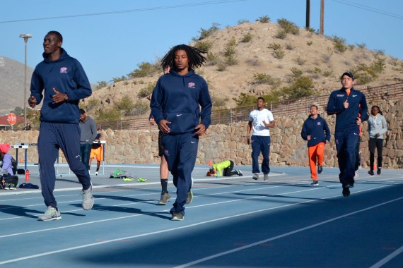 Men’s 4x4 relay members Abiola Onakoya (left) and Carnell Horn (right) warmup at the Kidd Field. 