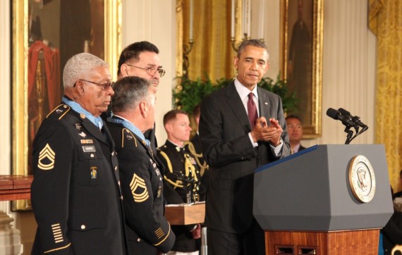 Sgt. 1st Class Melvin Morris, left, Master Sgt. Jose Rodela and Sgt. Santiago J. Erevia all Army soldiers during the Vietnam War, stand as President Barack Obama and a crowd applaud after they received the nation’s highest military honor, the Medal of Honor on Tuesday at the White House. Of 24 soldiers who received the award, they were the only three still alive.