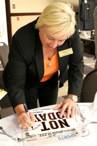 Coach Adams signs autographs for miner fans.