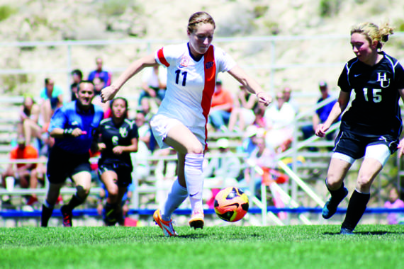 Sophomore forward Angela Cutaia eludes a New Mexico Highlands defender at University Field on April 13.