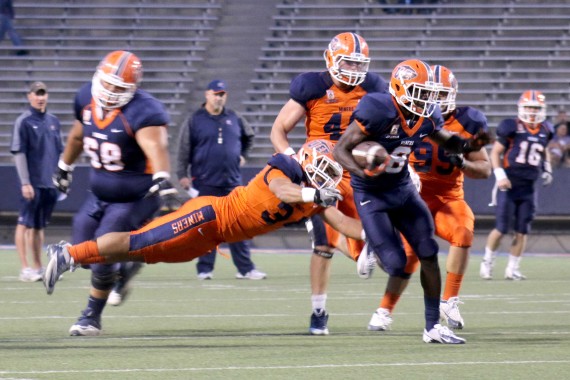 Sophomore running back Autrey Golden breaks a tackle from senior linebacker Anthony Puente during the Orange and Blue Game on April 11.