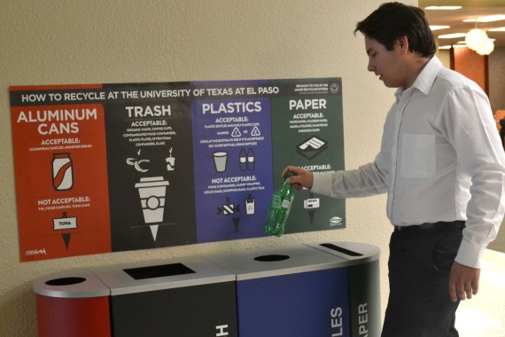 Student recycles at a multi-colored recycling bin, which will be placed all around campus by summer 2014.