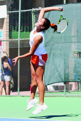 Junior Davina Meza hits a serve a first serve at the El Paso Tennis Club.
