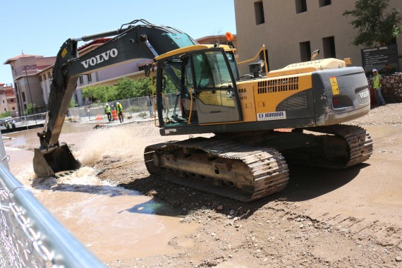 Construction workers begin to repair damage. 