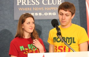 Erin Furleigh, a junior at Iowa State University, and Paul Gerlich, a sophomore, show two T-shirt designs for their school’s chapter of the National Organization for the Reform of Marijuana Laws during a news conference Tuesday. The university withdrew its approval of Furleigh’s shirt after initially approving it. She and Gerlich have sued the university. 
