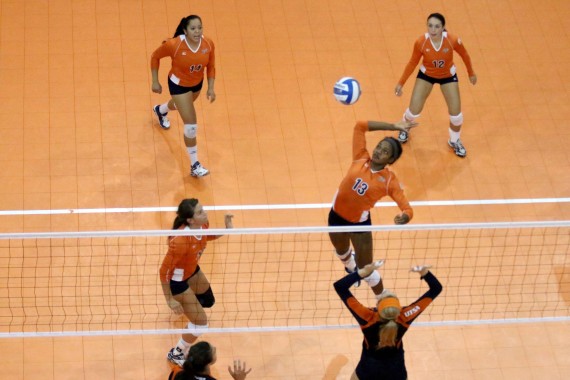 Freshman middle blocker Krystal Ejesieme spikes a ball set up by sophomore setter Lindsey Larson