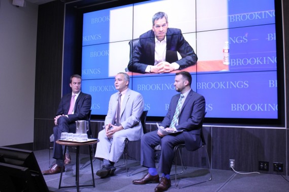 Wells Bennett, left, Benjamin Wittes, John Villasenor – on the screen – and Gregory McNeal say how federal and state governments regulate drones and other civilian robotics will affect when consumers can begin to use them.