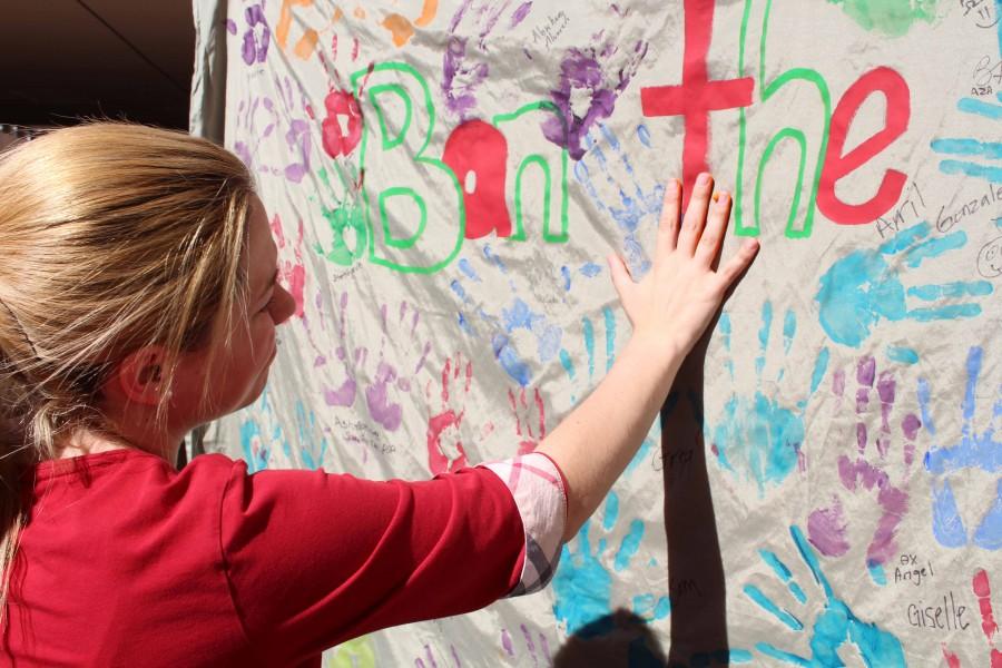 Noraliz Casanova places her handprint on the Ban the R word banner