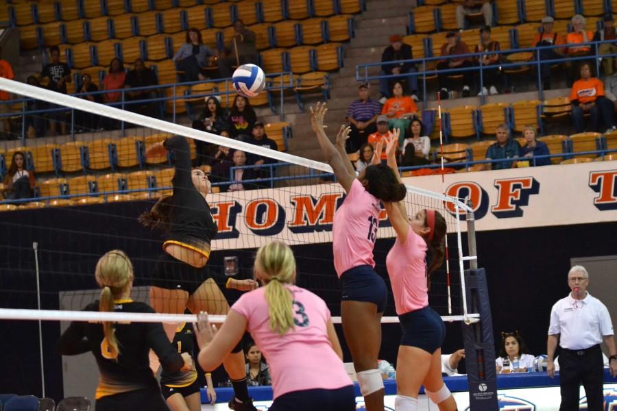 Krystal Ejesieme (left) and Lindsey Larson (right) jump to attempt a block on the Southern Miss attack 