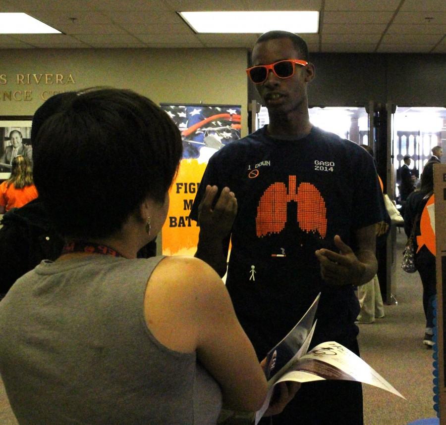 UTEP student David Bowens, a Health Promotions Major, informs a fellow student about the dangers of smoking tobacco. 