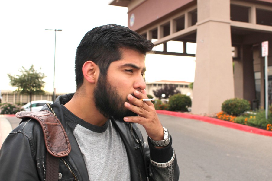 Senior metallurgical engineering major Fabian Alvarez smokes a cigarette after leaving campus.