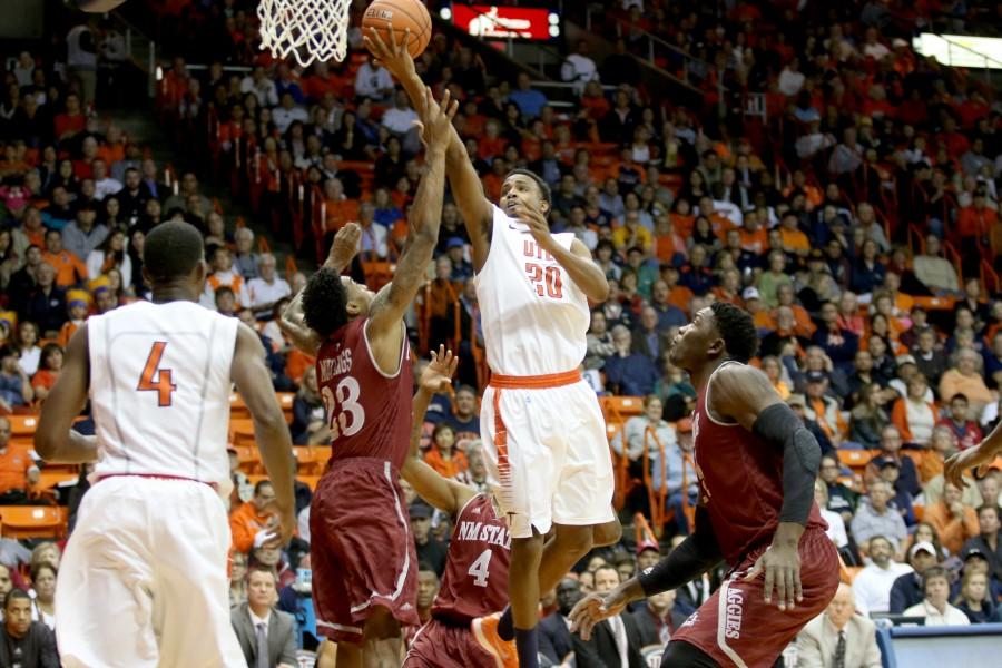 Junior guard Earvin Morris attempts a layup over Aggie defenders.