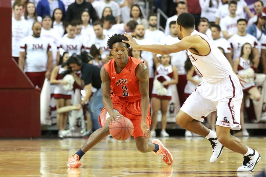 Freshman guard Omega Harris dribbles the ball past an Aggie defender. 