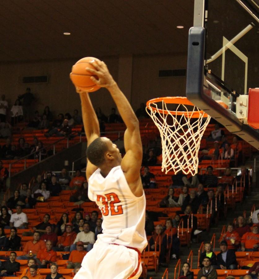 Vince Hunter slam dunks the ball. 