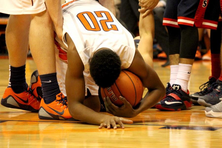 Junior guard Earvin Morris falls after a foul is called on Arizona. 