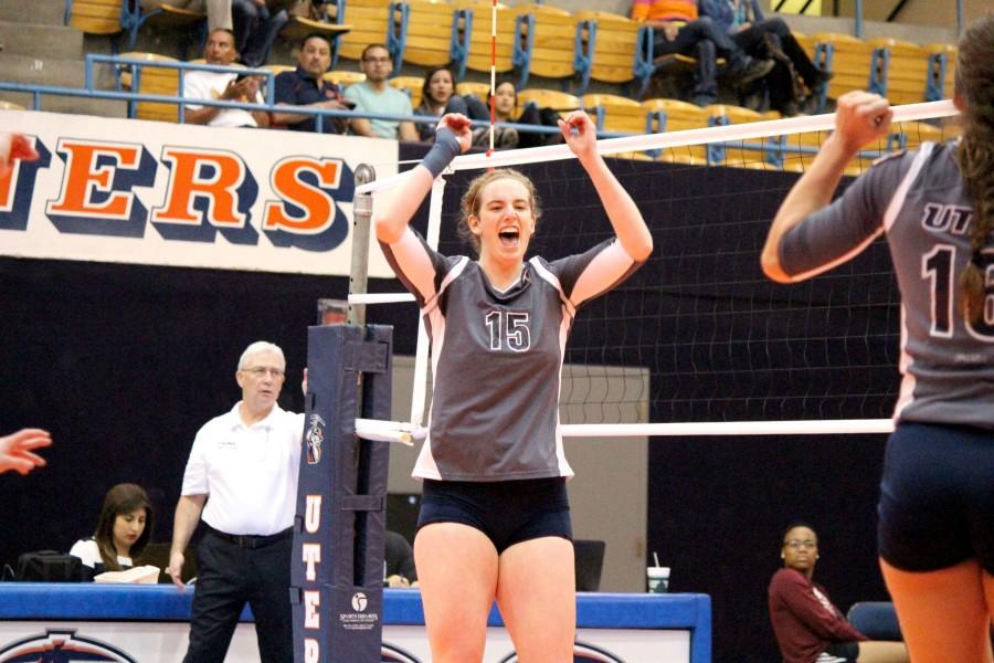 Senior outside hitter Jacqueline Cason turns towards her teammates to celebrate after winning a point.