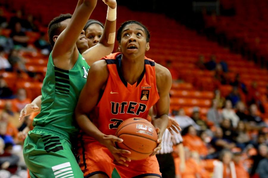 Junior forward Lawna Kennedy protects ball from UNT defender. 