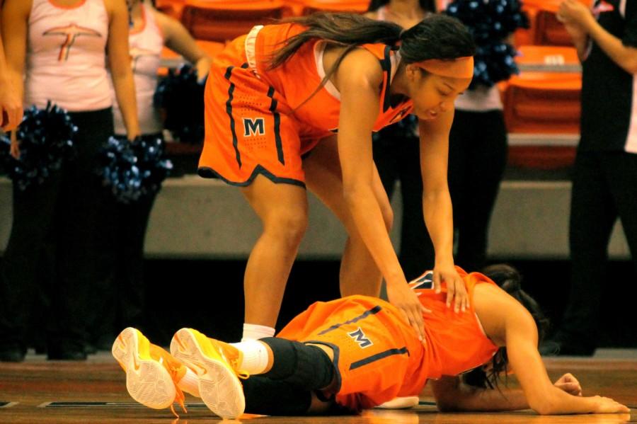 Cameasha Turner is embraced by a teammate after taking a hit to the face. 