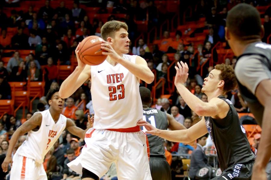 Junior center Hooper Vint protects ball from blue raiders defender. 