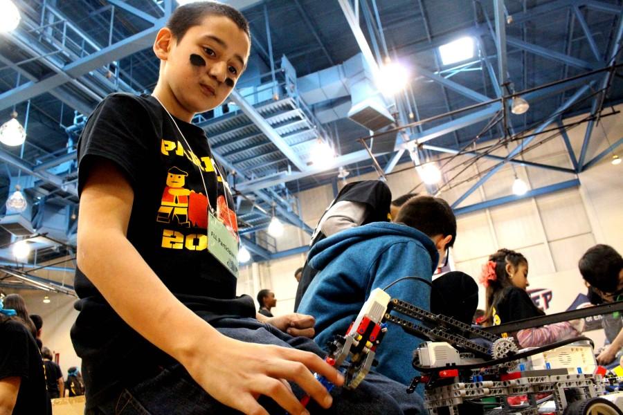 A Parkland Middle School student tries out his robot. 