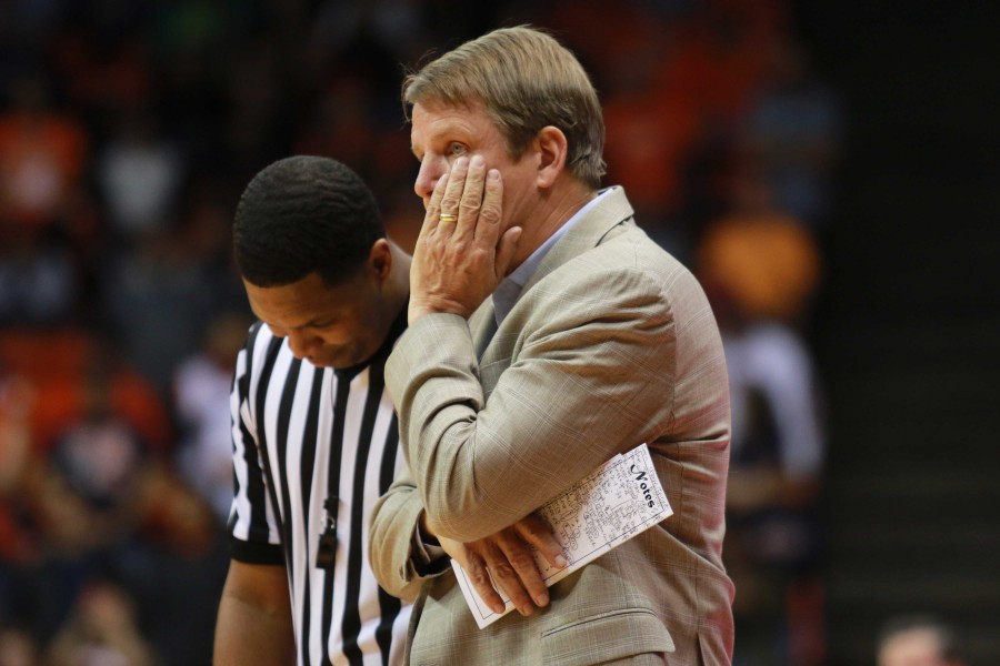 Head coach Tim Floyd questions a call with the referee. 