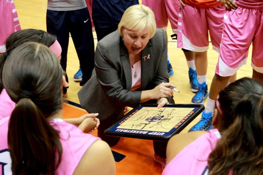 Head coach Keitha Adams discusses play with team. 