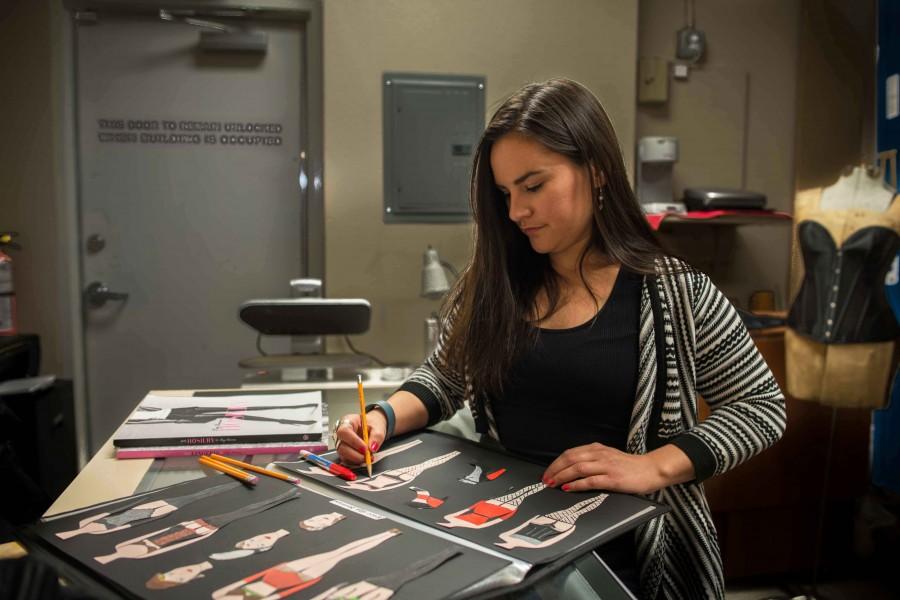 Owner of House of Dame Intimates, Gloria Reza works on her corset designs.