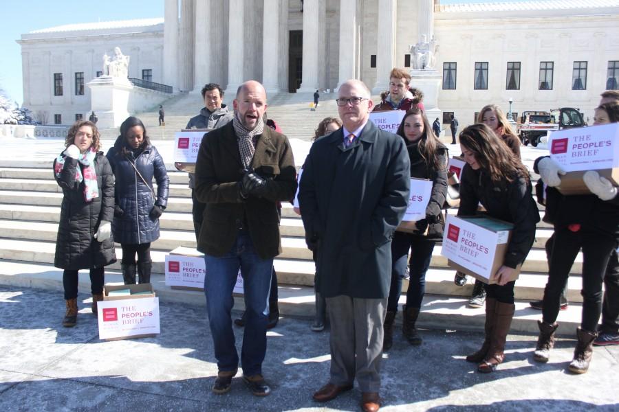 Fred Sainz, left, of the Human Rights Campaign, and Jim Obergefell, the lead plaintiff in the same-sex marriage case before the Supreme Court, and volunteers deliver what they call the People’s Brief, in advance of the April 28 argument in the case. 