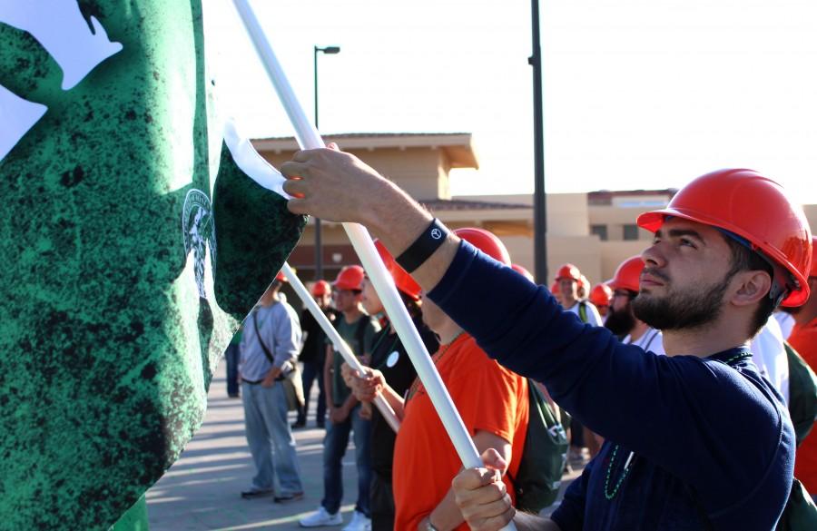 A UTEP student who participated on TCM Day gets his banner ready. 