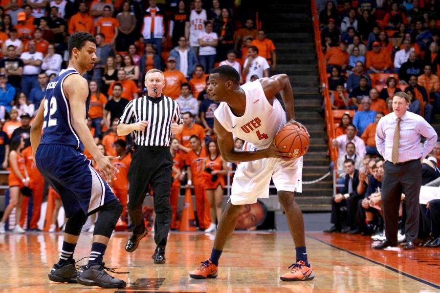 Senior guard Julian Washburn protects ball from Owls defender. 