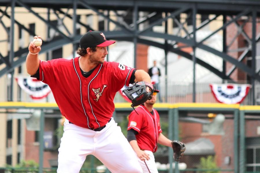 Chihuahuas third baseman Brett Wallace throws the ball toward first base during the team’s season opener.