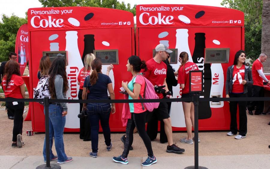 UTEP students personalize their coke cans near Leech Grove. 