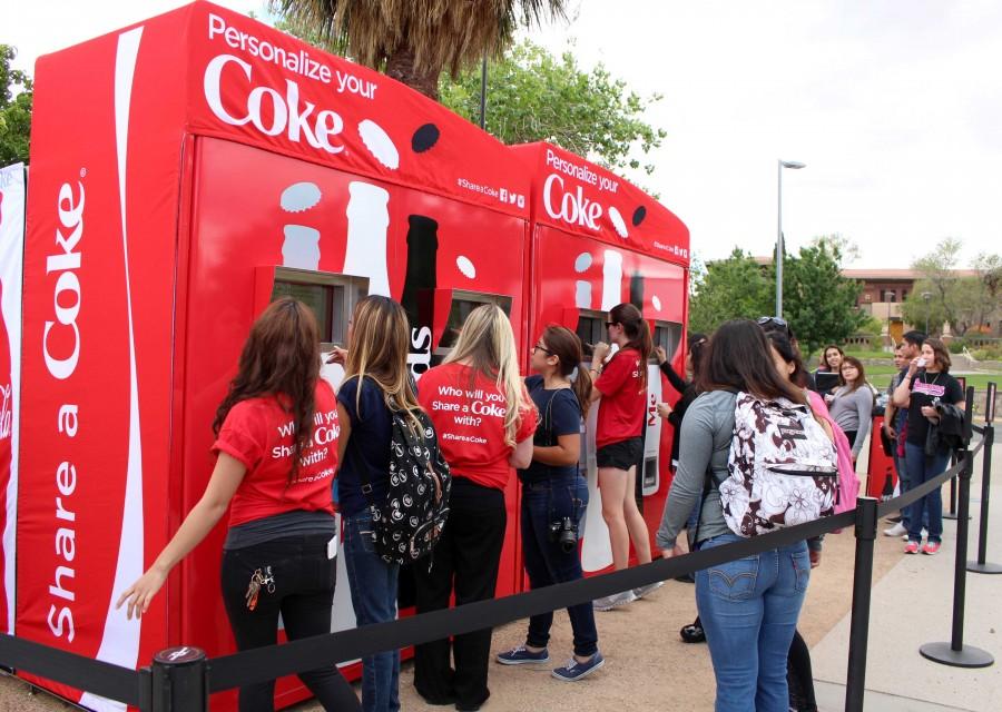 Students type out names on their personalized coke cans.