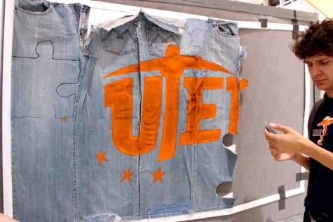 A UTEP student prepares a denim board. 