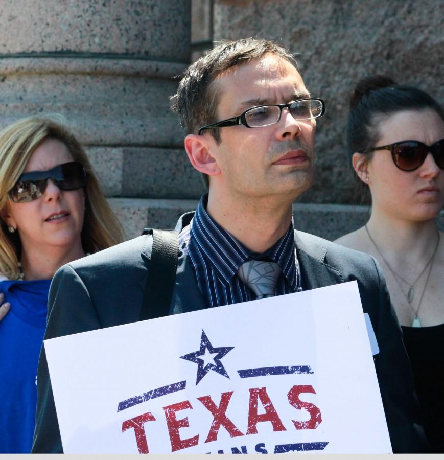 A participant at Freedom Advocacy Day listens to Chuck Smith, executive director of Equality Texas, speak.