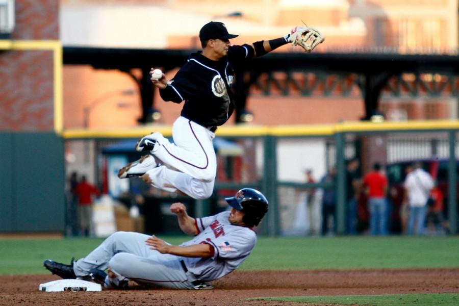 Second+baseman+Ramiro+Pena+avoids+the+slide+while+throwing+towards+first+base.+