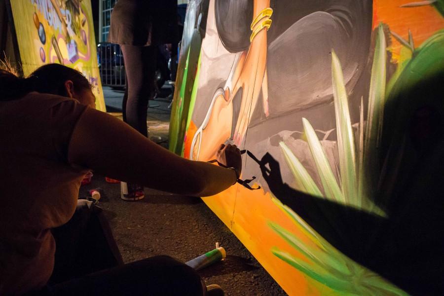 An artist paints at Neon Desert.